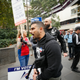 Provacateur Avi Yemini marches in front of a sign that says "protect our democracy from Islam."